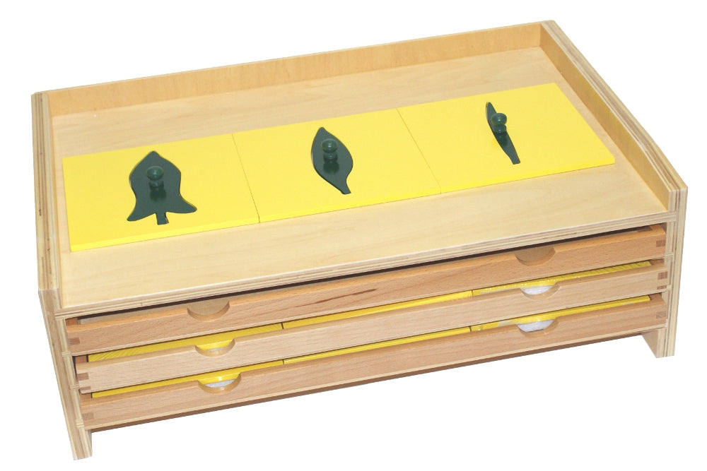 Botany leaf cabinet with three trays for a total of 18 insets. Inset frames are yellow with green leaves.