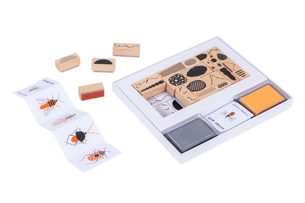 Wooden insect stamp kit. Each stamp is a part of an insect and can be mix-and-matched. A grey and a yellow stamp pad are included, along with an illustrated guide.