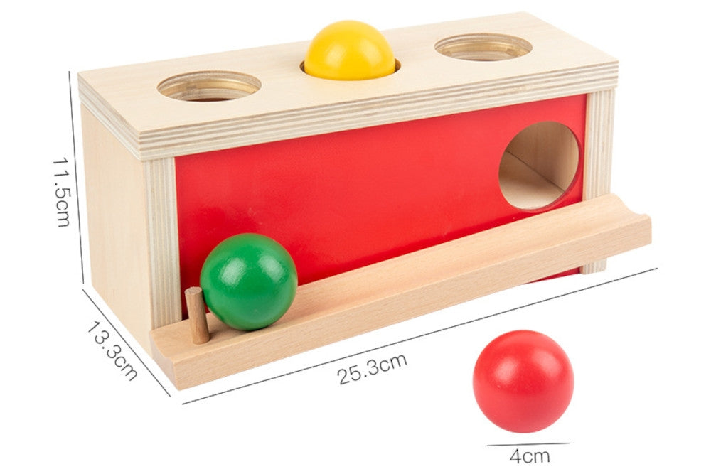 Ball push toy measuring 25.3 cm x 13.3 cm x 11.5 cm. Natural wood with red side and three balls in green, yellow, and red.