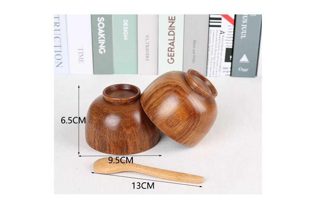 Two dark brown solid wood bowls with a light brown wooden spoon.