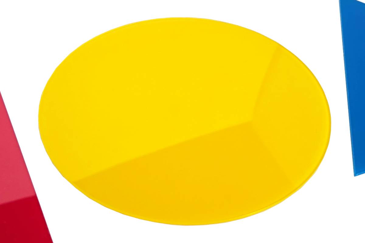 Close-up of reflective, glossy surface of yellow circle