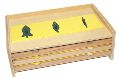 Botany leaf cabinet with three trays for a total of 18 insets. Inset frames are yellow with green leaves.