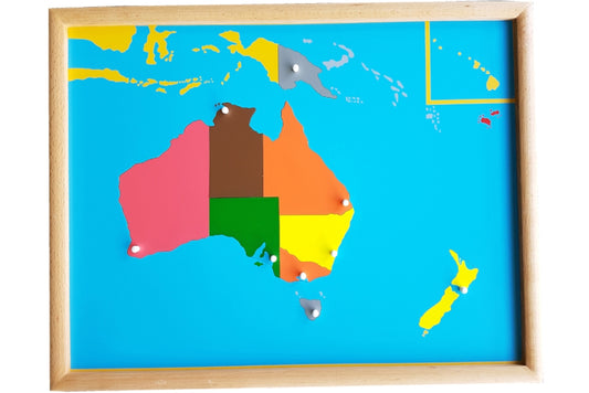 Puzzle map with pieces representing the countries in Oceania and the states of Australia in different colours. Each country or state's knob is positioned at its capital. The puzzle has a wooden frame.