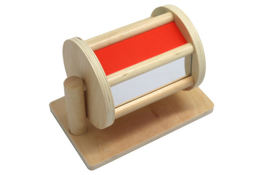 Colourful wooden spinning drum. A red side and a reflective side are visible.