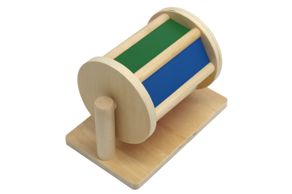 Colourful wooden spinning drum. A green side and a blue side are visible.