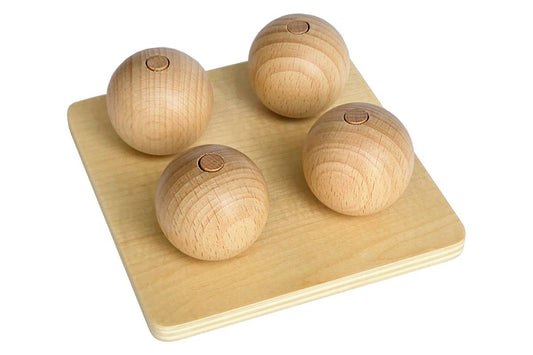 Four wooden balls, each on a vertical dowel flush with the top of the ball.