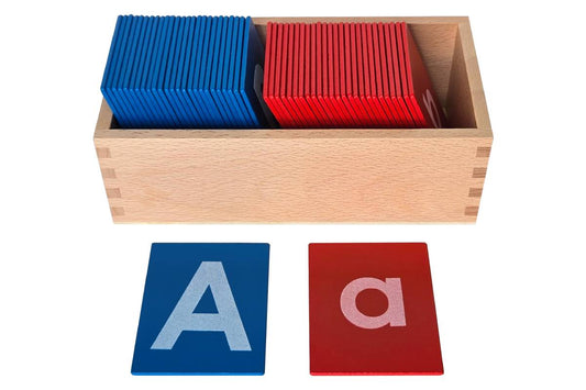Two-compartment wooden box with blue capital case sandpaper letters in one compartment and red lowercase sandpaper letters in the other.