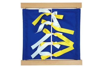 Wooden bow-tying dressing frame with blue fabric and yellow-and-white bows.