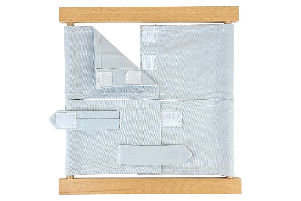 Wooden velcro dressing frame with grey fabric and white velcro.